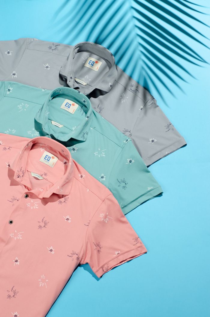 get-in-touch Three stylish polo shirts on a blue background with tropical shadow play.